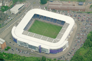 Luftaufnahme eines Fußballstadions in einer Stadt, umgeben von Gebäuden, Bäumen und Straßen mit Fahrzeugen, Heimat von Tottenham Hotspur Football Club.