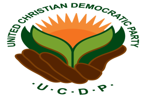 Logo der Vereinigten Christdemokraten (UCDP) mit einer Hand, die eine leuchtend gelbe Blume mit grünem Stiel und Blättern hält, vor einem weißen Hintergrund mit einem blauen und gelben Kreis. Der Text "UCDP" ist in fetter schwarzer Schrift darunter geschrieben.