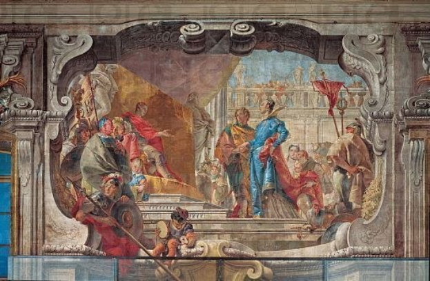 Ein lebendiger und detaillierter Fresko auf einer Decke, das eine Gruppe von Menschen, Skulpturen und Gegenstände in einem realistischen Stil mit verschiedener traditioneller und moderner Kleidung darstellt.