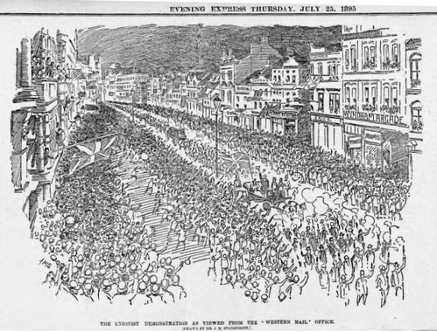 Schwarze und weiße Zeichnung einer Menge von Menschen, die eine von Gebäuden gesäumte Straße entlanggehen, mit der Überschrift "Die Unionistendemonstration, wie sie vom Western Mail Office aus gesehen wird" oben und unten.