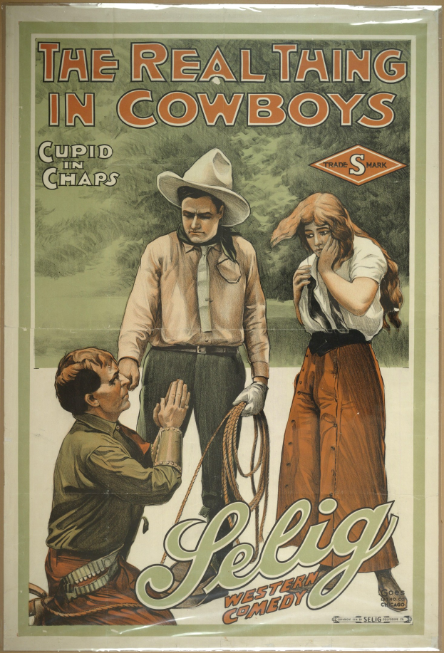 Plakat an einer Wand mit drei Personen in Cowboy-Kleidung und "The Real Thing in Cowboys" oben drauf, vor einem hellgelben Hintergrund.